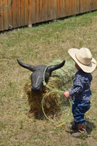 Little kid cowboy practicing his roping skills at the Haines Stampede Junior Rodeo 