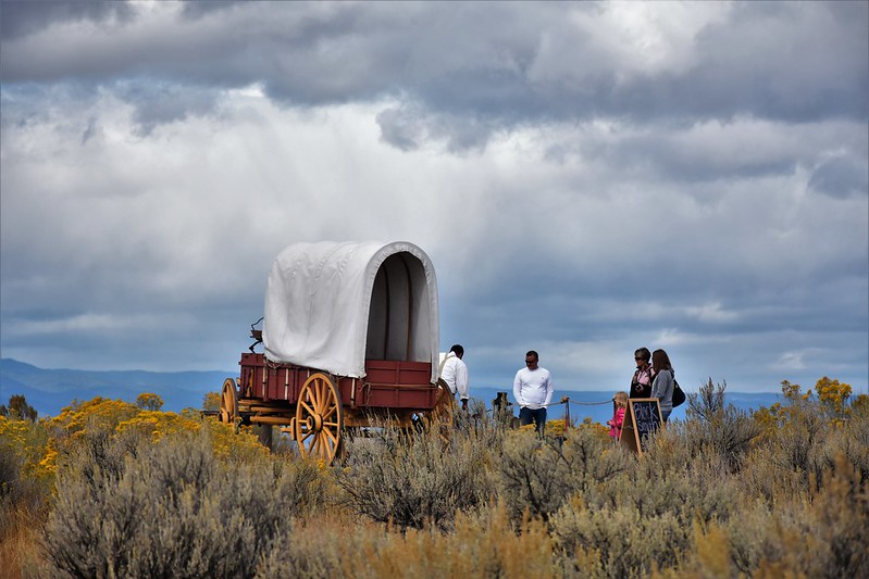 Covered wagon under stormy skies amid the sagebrush on the Oregon trail
